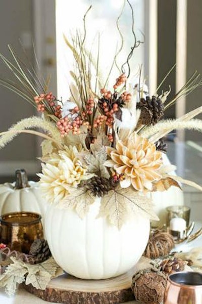 A simple, seasonal centerpiece from a Pumpkin and a Princess was created by adding faux florals.