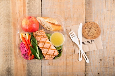 Roasted salmon with citrus vinaigrette served on a bed of fresh greens, served with a baguette roll, seasonal fruit, or a chocolate chip cookie, by Bi-Rite Catering in San Francisco
