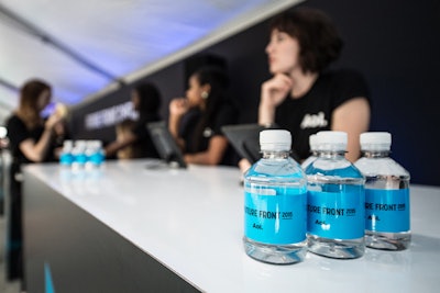 Check-in desks offered branded mini water bottles.