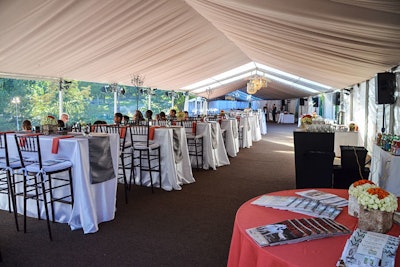 The aptly named Veranda dining area was erected on a custom platform covered with stock tenting. The custom dinner configuration, with buffet food and beverage service provided by Relish Catering, ran the length of about 150 by 30 feet as a long, narrow venue. It was elevated about four feet to maintain an optimal sight line to the course. The Treehouse venue located directly across the course required a slightly more complex build out because it had to be designed around existing landscaping and trees. Access to that V.I.P. viewing area was via a completely separate entrance and its own exterior gate, which required cutting open existing fencing.