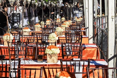 A uniform autumnal flavor highlighted each of the vertical dinner tables inside the V.I.P. tent. Low centerpieces allowed for clear sight lines while, at night, electronic votives placed on taller branch vignettes provided a cozy ambience. Sponsor brands, like Rolex, were free to add elements to customize their tables.