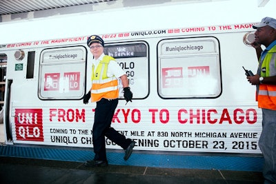 The exterior of the train is wrapped in the brand's logo, a sign that reads 'From Tokyo to Chicago,' and information pertaining to the store opening.