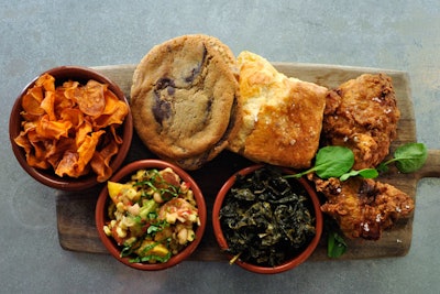 Fried chicken with buttermilk dressing, served with a house-made biscuit, long-cooked cavolo nero, summer succotash salad, and a chocolate chip or oatmeal cookie, by the Larder in Los Angeles
