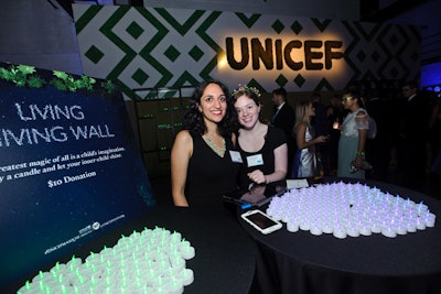 Another activity was the 'Living Giving Wall.' For $10 apiece, guests could purchase green or blue LED lights. They placed their candles on a wall, and throughout the evening, guests could see which team was donating more to the wall.