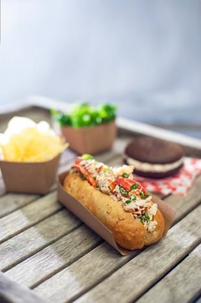 Nova Scotia lobster in chive mayonnaise, served in an artisanal bun, along with kettle chips, bean, snow and snap peas, broccoli salad, and a chocolate whoopie pie, by En Ville Event Design & Catering in Toronto