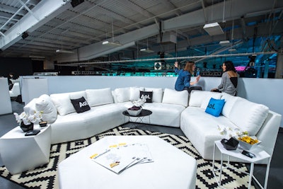 Keeping with the event's black-and-white color scheme—an AOL event staple—the lounge area featured white sofas and tables contrasted with black pillows, vases, and napkins. Snacks included nuts and plantain chips.