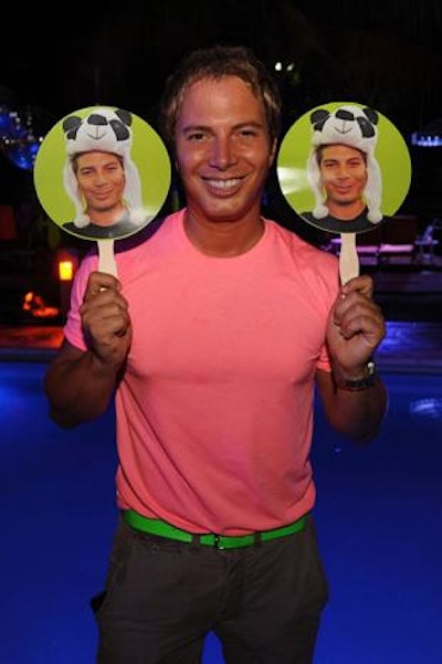 D'Annunzio (pictured) provided neon paper fans with his likeness to help guests beat the heat at the summer party, which was dubbed the 'Neon or Nothing Night Swim.'