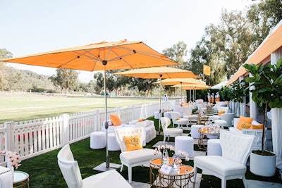 Umbrellas in the brand's color popped against white seating arrangements.