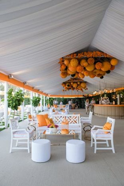 A bold chandelier-like decor piece hung over the white tented Secret Garden space.