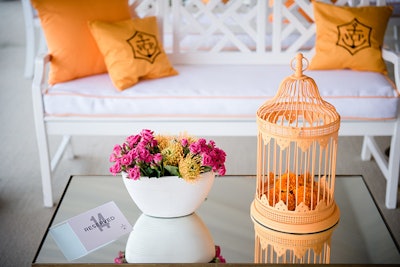 Birdcages, pillows, and other objects in Veuve Clicquot's signature yellow-orange color decorated the party space.