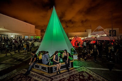 There were several areas for guests to kick back and take a breather from all the stimulation. Muse Directive created glowing, pointed structures surrounded with Persian rugs. The areas provided extra seating and proved a popular backdrop for photos.