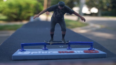 Skateboarder doing rail slide