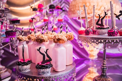 Bella Christie and Lil Z's Sweet Boutique provided a dessert station for the Tattoos and Tassels party, incorporating the pink, black, and silver colors of the event space into sweet treats like cake pops, mini cupcakes, and cookies and milk.