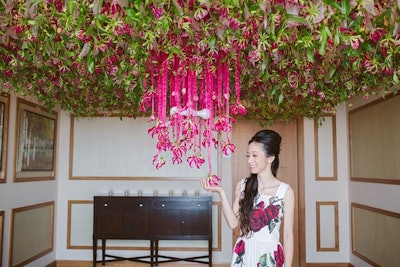 Tran suspended strings of gloriosa lilies to cover a wall of the suite and create a backdrop for photos.