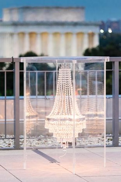 At a Hosts DC event held at the Potomac View Terrace, Landover, Maryland-based Amaryllis Floral & Event Design debuted a new specialty high-top table, which features a crystal chandelier encased in a modern Lucite box. Pricing is available upon request.