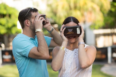 Guests placed their smartphones inside cardboard viewers to watch the virtual reality video.