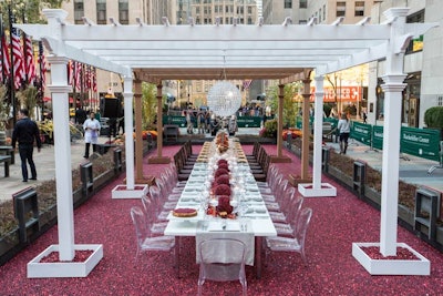 The long dining table, housed inside a watertight rubber membrane, was anchored by two large custom 12- by 12-foot pergolas overhead complete with theme-appropriate chandeliers. Inside the 20- by 60-foot bog were 900,000 cranberries floating in 21,000 gallons of water.