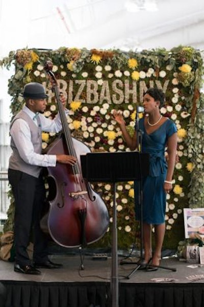 At the entrance to the expo floor, Acute Inflections performed in front of a flower wall, which was created by Larkspur Botanicals and featured the event hashtag #BizBashNY.