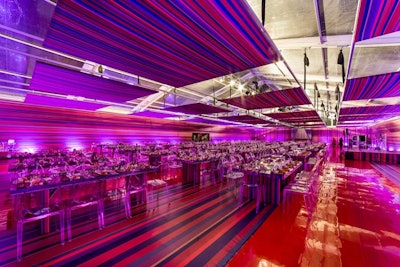 The auction took place in a tented space decked with multicolored striped fabrics. Colors included red, burnt orange, royal blue, golden yellow, and chartreuse green.