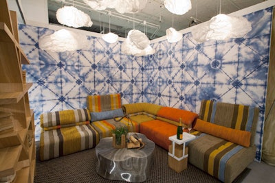 Tie-dye pattern walls surrounded an installation from Modern Luxury Interiors Chicago, Roche Bobois, and Nicholas Moriarty Interiors. Dubbed 'A Modern Encampment,' the space was meant to have an indoor-outdoor feel and channel a modern boutique hotel.