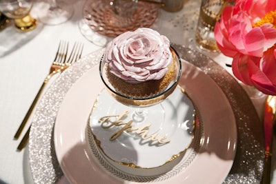 Each place setting at Debi Lilly's table had sparkling charger plates and coupe glasses holding cupcakes with floral frosting designs.