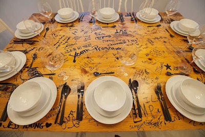 Yet another linen and flower-free table was designed by Thomas Interior Systems and Siebold & Baker by Eastlake Studios. The installation featured a table that had traveled to 10 Chicago communities and served as a pop-up dining space. Those who gathered at the table were encouraged to write on its surface.