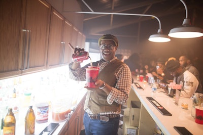 Guests can order mixed drinks at various spots in the house, including a bar that resembles a typical kitchen counter.