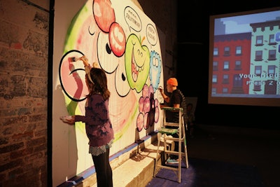 Artist Kevin Lyons and his daughter painted a Jolly Rancher mural for the exhibit.