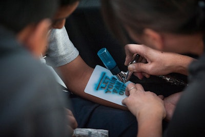 Airbrush tattoos offered to fans attending the event matched the 'Let Your Fan Out' campaign messaging.