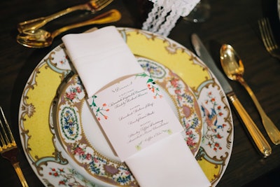 Revolution Event Design and Production kept the Downton Abbey theme alive at dinner with antique-style plates and delicate lace and floral details on the menu cards.