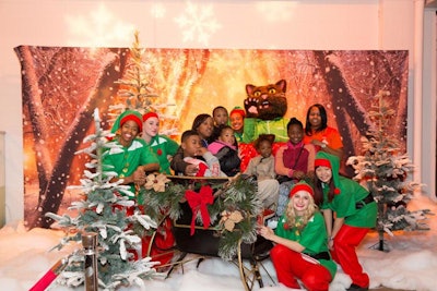 A photo opportunity let guests pose in a sleigh with Christmas elves and Groupon's feline mascot, Groupon the Cat.