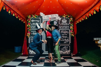 Another tent held a photo booth, where guests donned costumes inspired by the fairy tale's Mad Hatter character.