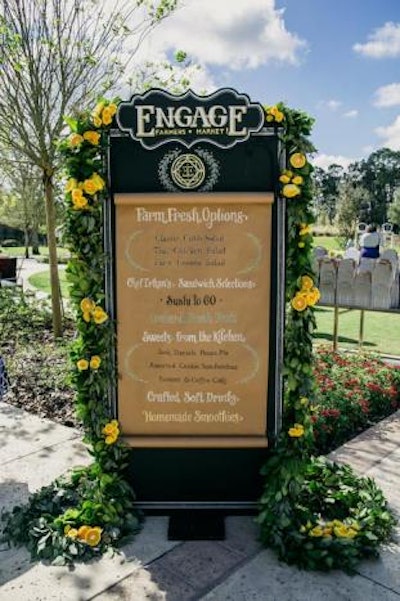 A picnic-style lunch on the resort's King Meadow Lawn took place on Friday. The menu, displayed at the entrance, offered items such as Cobb salad, sushi, and scones and coffee cakes.