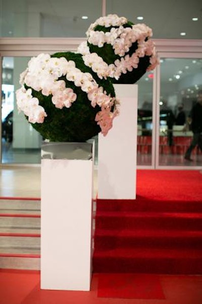 Swirling floral arrangements also referenced the idea of cars, motion, and the building's architecture.