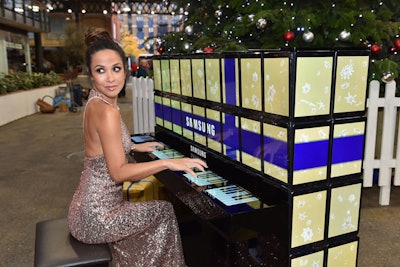 Musician Myleene Klass entertained guests by playing festive songs at the London market.