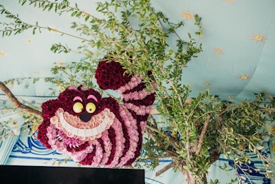 Alice in Wonderland's Cheshire cat character was rendered in flowers at the opening party.