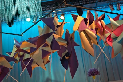 At the Pediatric Oncology Group of Ontario gala in April 2013, giant colorful pinwheels hung above diagonally arranged lounge furniture in shades of pink, yellow, and purple.