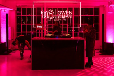 Custom neon signage from Let There Be Neon NYC decorated the DJ booth, where DJ Vashtie spun.