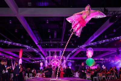 A performer on a rubberized pole appeared to defy gravity as she soared in all directions over the crowd.