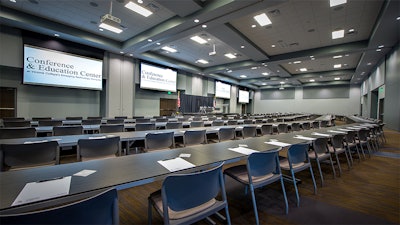 A side-view of a large conference setup in room 101 at the Victoria College Conference & Education Center.