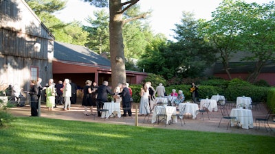 A cocktail reception outside the Oliver Wight Tavern and Fuller Conference Center.