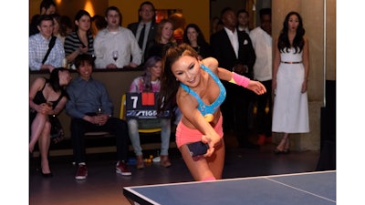 Soo Yeon Lee battles The Fat Jewish in an intense game of ping pong using a cellphone instead of a paddle during SPiN Chicago’s grand opening party.