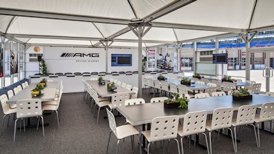 The inside of the AMG Driving Academy features seating, food service, graphics, and multimedia.