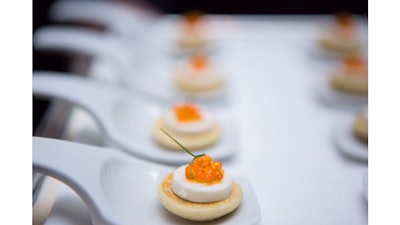 Per Se’s potato blini with smoked sturgeon cream cheese, trout roe, and snipped chives