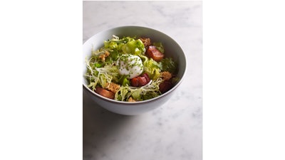 Escarole, frisée, bacon lardons, poached egg, and bacon vinaigrette with palladin croutons at Bouchon