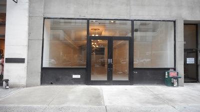 This storefront has large windows, a wide entrance, and is located at the busiest intersection in Flatiron.