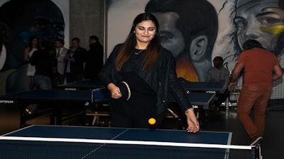 A model from SPiN Chicago’s Model Citizen night plays a game of ping pong.