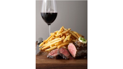 Pan-seared flat iron, caramelized shallots, and maître d’hôtel butter, served with French fries at Bouchon