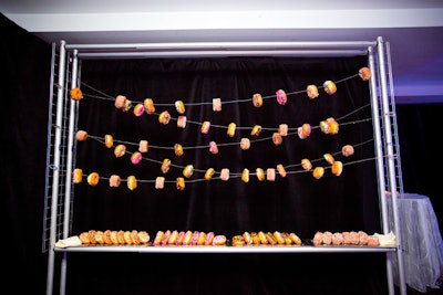 At a 40th birthday party, the JDK Group strung doughnuts as decor above the serving table.