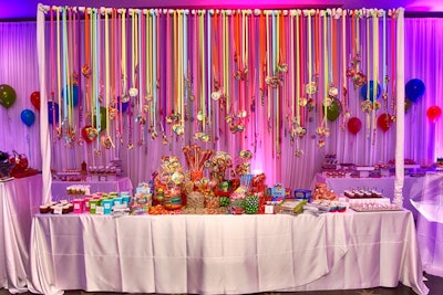 An Illinois bar mitzvah on March 12 had a Candy Land theme. Designer Event Chicago planned the event, as well as the design and concept for a sweets table—actually part of an entire sweets room—over which colorful candies dangled from multicolored ribbons of varying lengths. HMR Designs handled decor.